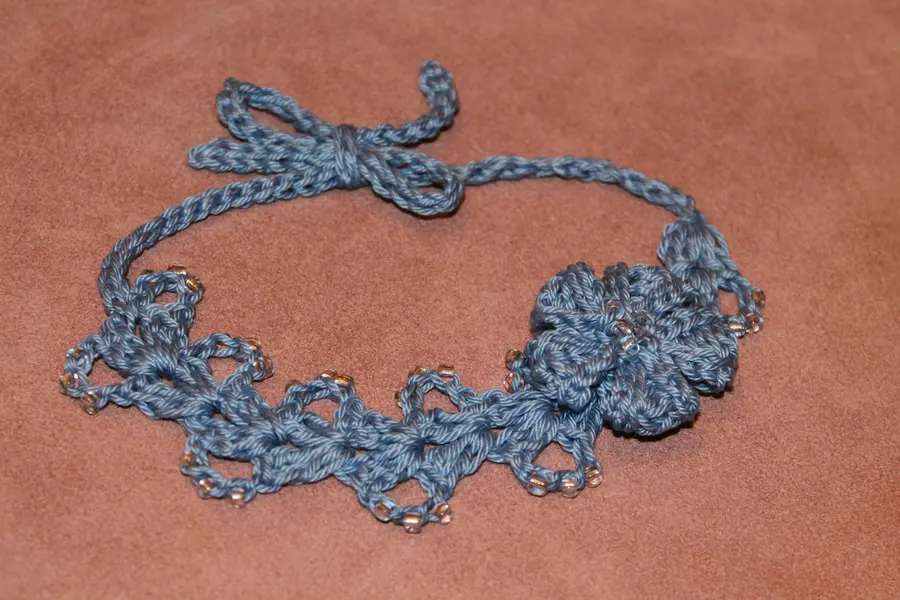 Finished crochet headband with the beaded flower